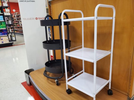 White supply cart with wheels. Black supply cart with wheels