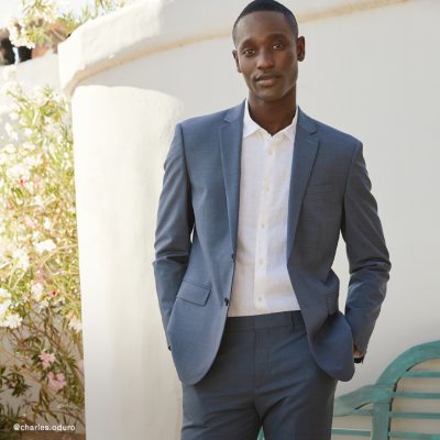 Man wearing grey suit with white shirt.