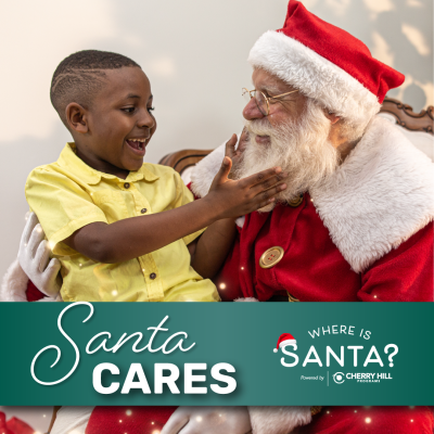 Little boy sitting on Santa's lap for Santa Cares